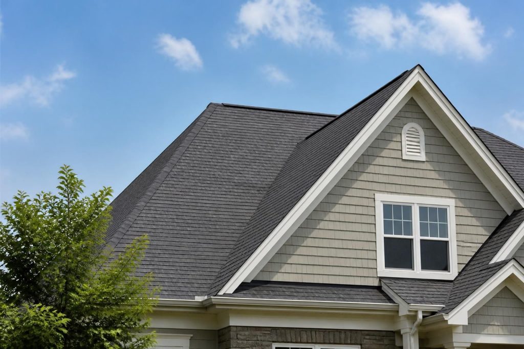 Well-maintained home roof with clean shingle lines under daylight.